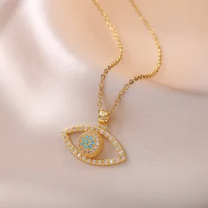Elegant gold Evil Eye necklace featuring blue beads and white zircon stones on silk