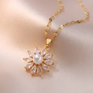 Golden sunflower necklace with a central pearl and zircon petals on pink silk background