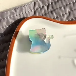 Macro shot of cute acetate cat hair claw clip with colorful iridescent gradient finish
