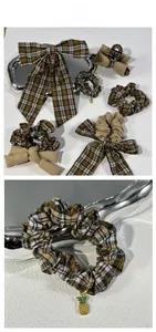 Detail view of plaid bow hair clip and scrunchie with a gold pineapple pendant