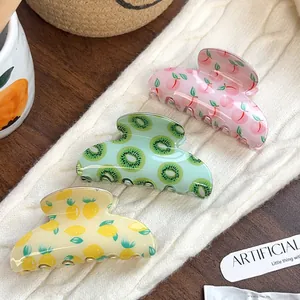 Three-piece set of fruit print hair claws featuring peach, kiwi and lemon designs
