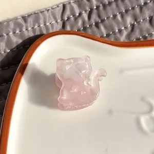 Detail of pink cat acetate hair claw clip showing glossy resin texture and teeth