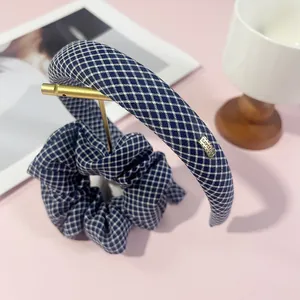 Blue and white plaid headband and scrunchie set with a small metal Lovedays tag