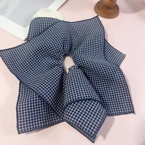 Deep blue and white gingham oversized scrunchie with frayed edges for elegant hair styling