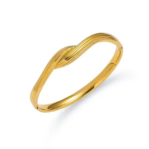 Macro shot of gold hollow Roman numeral bangle showing refined texture and hinge detail