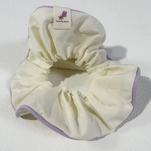 Off-white cotton scrunchie with lavender piping and lavender floral embroidery detail