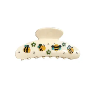 Pinza per capelli in acetato crema con api, fiori verdi e piccoli strass luminosi