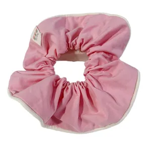 Pink candy-colored fabric scrunchie with cream piping and a cute carrot label