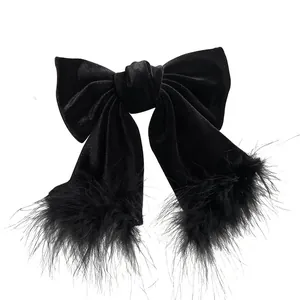 Elegant large black velvet bow hair clip with decorative soft feather tassels and spring clip
