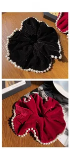 Detail of velvet pearl scrunchies in black and wine red with elegant vintage styling