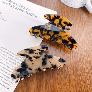 Large acetate hair claws in amber tortoiseshell and marble patterns for women