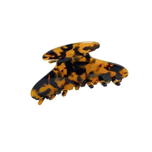 Classic tortoiseshell acetate hair claw clip with sleek streamlined design on white background