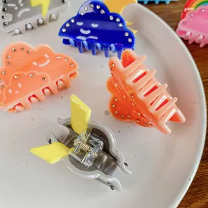 Chic weather-themed small hair claws featuring sun and cloud designs with rhinestones
