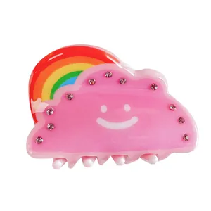 Rainbow cloud hair claw clip with pink glitter resin and a minimalist smile design