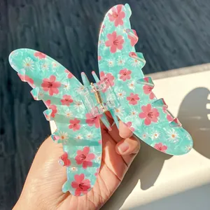 Floral butterfly hair claw clip with pink cherry blossoms and gold metal spring