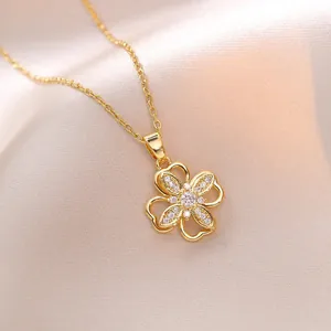 Elegant gold titanium rotating flower necklace with zircon heart petals on silk fabric