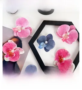 Macro view of artificial Phalaenopsis orchid hair clips with pearls and silk petals