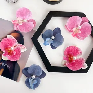 Elegant Phalaenopsis orchid hair clips with pearls shown in various pastel gradient colors
