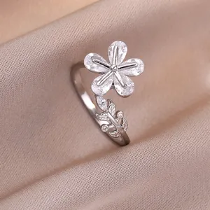 Adjustable silver flower ring featuring pear-cut zircon petals on a satin background