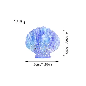 Deep blue shell-shaped shark hair claw with rhinestones and marble texture detail