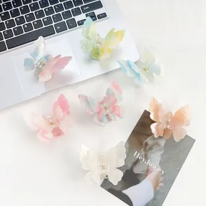 Flat lay of colorful gradient butterfly hair claws in acetate and pearlescent finishes