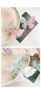 Detail display of butterfly hair clips with gradient colors and fine glitter finish