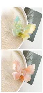 Close-up of elegant double-layered butterfly hair clips with marble gradient texture
