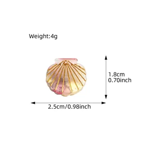 Mini shell-shaped acetate hair claw clip with gold stripes and size dimensions