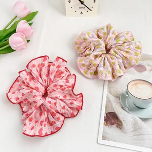 Floral print scrunchies in pink and lavender patterns for high ponytail styling
