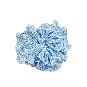 Floral print scrunchie in blue and white fabric for elegant ponytail hairstyling