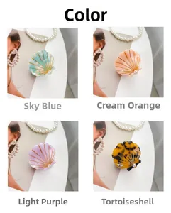 Shell-shaped hair claws in four colors with gold lines and pearl details