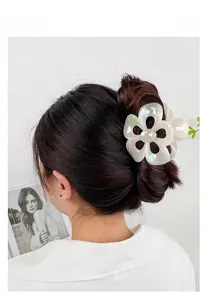 Detail of flower hair claw clip with pearlescent finish used for elegant updos