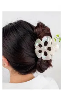 Iridescent white flower hair claw clip shown in a stylish hairstyle on a model
