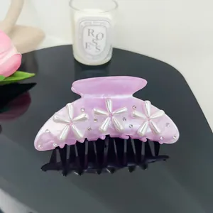 Elegant pink hair claw clip with pearl flowers and sparkling rhinestone accents