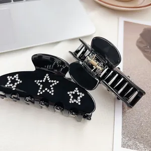 Eleganter großer schwarzer Haarklammer mit funkelnden Strass-Sternen und Metallfeder