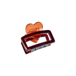 Pince à cheveux minimaliste en acétate avec cadre brun-rouge et détail de cœur orange