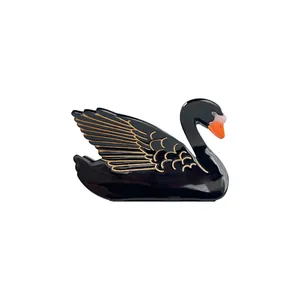Elegant black swan acetate hair claw clip with golden feather details on white background