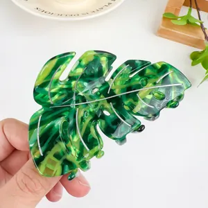 Tropical monstera leaf hair claw clip with green marbled acetate finish and silver veins