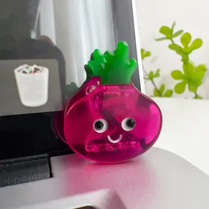 Macro shot of cute pink beet-shaped acetate hair claw with funny cartoon face design