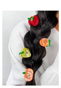 Detail of colorful fruit-shaped acetate hair clips styled on a dark braided hairstyle