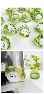 Detail of cute green cabbage hair claw clip with a smiling cartoon face and metal spring