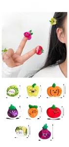 Detail of vegetable-themed acetate hair clips with weights and size measurements
