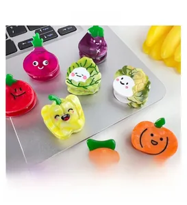 Close-up of colorful acetate hair clips in cute vegetable shapes on a laptop