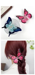 Detailed view of pink and blue acrylic butterfly hair clips with metal spring mechanism