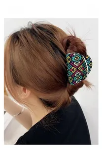 Close-up of bohemian pattern acrylic claw clip holding a hairstyle for daily wear