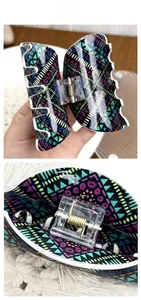 Macro view of Bohemian acrylic hair claw with geometric patterns and golden metal spring