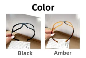 Detail view of wave hair hoops in black and amber with unique eyeglass frame design
