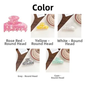 Detailed close-up of colorful PVC claw clips in five shades with smooth marble texture