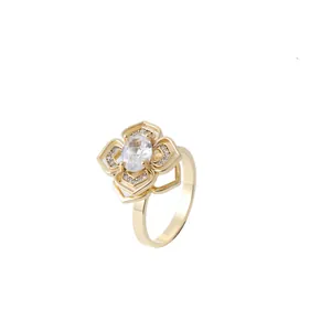 Golden flower ring featuring layered hollow petals with micro-pave crystals and center stone