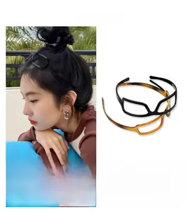 Detailed view of creative glasses-shaped headbands in black and amber tortoiseshell